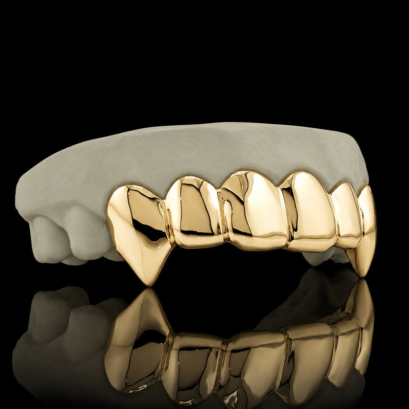 Yellow gold plated fangs on a dental model
